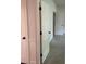 Hallway with three paneled doors, carpet, and white trim at 4482 Ridge Mill Ne Ter, Douglasville, GA 30135