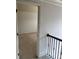 Upstairs hallway with neutral carpet and open doorway leading to bedroom or bonus room at 4482 Ridge Mill Ne Ter, Douglasville, GA 30135