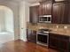 Modern kitchen with stainless steel appliances, dark cabinets, and hardwood floors at 4482 Ridge Mill Ne Ter, Douglasville, GA 30135