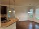 Kitchen island with stone countertop and stainless steel sink near formal dining area at 4482 Ridge Mill Ne Ter, Douglasville, GA 30135