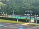 A community pool with lounge seating surrounded by trees at 4482 Ridge Mill Ne Ter, Douglasville, GA 30135