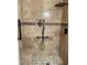 Modern shower features stone tile, a built-in shelf, and sleek, dark hardware at 4482 Ridge Mill Ne Ter, Douglasville, GA 30135