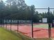 A fenced tennis court within the community at 4482 Ridge Mill Ne Ter, Douglasville, GA 30135