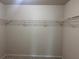 Empty walk-in closet features wire shelving and neutral colored walls and carpet at 4482 Ridge Mill Ne Ter, Douglasville, GA 30135