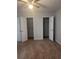 Bedroom with neutral carpet, ceiling fan, and dual walk-in closets offering ample storage at 5425 Village Green Sq, Norcross, GA 30093