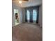 Bedroom with carpet, ceiling fan, and curtains. Bathroom through doorway at 5425 Village Green Sq, Norcross, GA 30093