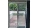Patio door leads to outdoor wooden deck overlooking the trees at 5425 Village Green Sq, Norcross, GA 30093