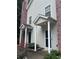 Exterior view of home with front door covered by columns and porch roof at 5425 Village Green Sq, Norcross, GA 30093