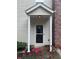 Inviting front entrance with a portico and red flowers adding charm and color at 5425 Village Green Sq, Norcross, GA 30093