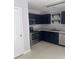 Galley kitchen featuring stainless steel appliances and navy cabinetry at 5425 Village Green Sq, Norcross, GA 30093
