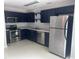 Galley kitchen with stainless steel appliances and blue cabinets offering style and functionality at 5425 Village Green Sq, Norcross, GA 30093