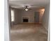 Spacious living room with a fireplace, neutral carpet, and a gray front door at 5425 Village Green Sq, Norcross, GA 30093