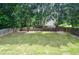 Spacious backyard featuring well-maintained lawn and mature trees at 930 Cedar Bluff Sw Trl, Lilburn, GA 30047