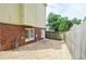 Exterior shot of the house, showing the brick foundation and stone gravel area at 930 Cedar Bluff Sw Trl, Lilburn, GA 30047