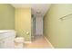 Bathroom featuring light green walls, tile flooring, and white cabinets at 930 Cedar Bluff Sw Trl, Lilburn, GA 30047