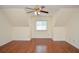 Spacious bedroom with hardwood flooring, slanted ceilings, ceiling fan, and a well lit window at 930 Cedar Bluff Sw Trl, Lilburn, GA 30047