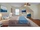 Staged bedroom features a queen bed, neutral color palette, and is staged with a mountain theme at 930 Cedar Bluff Sw Trl, Lilburn, GA 30047