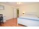 Bedroom with wood flooring, white walls, and a bed and study area at 930 Cedar Bluff Sw Trl, Lilburn, GA 30047
