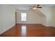 Empty bedroom with hardwood floors, bright window, ceiling fan and neutral color palette at 930 Cedar Bluff Sw Trl, Lilburn, GA 30047