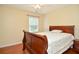 Charming bedroom with light walls, hardwood floors, and a bright window for natural light at 930 Cedar Bluff Sw Trl, Lilburn, GA 30047