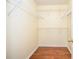 Spacious walk-in closet features hardwood floors and adjustable shelving for optimal storage at 930 Cedar Bluff Sw Trl, Lilburn, GA 30047