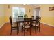 Sunny dining room with views, wood floors, and updated fixtures at 930 Cedar Bluff Sw Trl, Lilburn, GA 30047