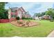 Beautiful brick house with a lush front lawn and well-kept landscaping features at 930 Cedar Bluff Sw Trl, Lilburn, GA 30047
