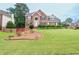 Traditional brick home with manicured lawn, dark shutters, and well-maintained landscaping at 930 Cedar Bluff Sw Trl, Lilburn, GA 30047