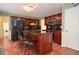 Kitchen with wooden cabinets, granite countertops, stainless steel appliances, and breakfast bar at 930 Cedar Bluff Sw Trl, Lilburn, GA 30047