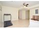Living room features tile flooring, a treadmill and neutral walls at 930 Cedar Bluff Sw Trl, Lilburn, GA 30047