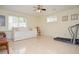 Bright rec room featuring tile flooring, a bed, and exercise equipment at 930 Cedar Bluff Sw Trl, Lilburn, GA 30047