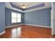 Large main bedroom with hardwood floors, tray ceiling, ceiling fan, and big window at 930 Cedar Bluff Sw Trl, Lilburn, GA 30047