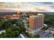 Beautiful high-rise building with pool surrounded by lush greenery and a cityscape view at 1820 Peachtree St # 1607, Atlanta, GA 30309