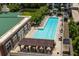 Rooftop pool and lounge area with seating, lush landscaping, and an adjacent green space at 1820 Peachtree St # 1607, Atlanta, GA 30309
