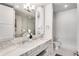 A bright bathroom with double sinks, marble countertops, and a separate glass enclosed shower at 1820 Peachtree St # 1607, Atlanta, GA 30309