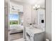 Bright bathroom with a marble countertop, white cabinets, and a view of the bedroom at 1820 Peachtree St # 1607, Atlanta, GA 30309