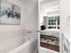 Bathroom featuring a soaking tub and a doorway that leads to the main bedroom with exterior views at 1820 Peachtree St # 1607, Atlanta, GA 30309