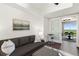 Bedroom area with a comfortable sofa, workspace, and access to a living room with a view at 1820 Peachtree St # 1607, Atlanta, GA 30309