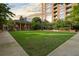 Beautifully landscaped green space featuring a brick building and manicured greenery for outdoor enjoyment at 1820 Peachtree St # 1607, Atlanta, GA 30309