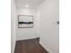 Hallway with wooden floorboards, art hanging on the wall, and neutral colors at 1820 Peachtree St # 1607, Atlanta, GA 30309
