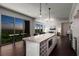 Open kitchen and living area featuring hardwood floors and large windows with sunset views at 1820 Peachtree St # 1607, Atlanta, GA 30309