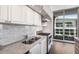 Stylish kitchen featuring granite countertops, stainless appliances, and a view of the outdoor space at 1820 Peachtree St # 1607, Atlanta, GA 30309