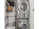 Stackable stainless steel washer and dryer with storage racks above at 1820 Peachtree St # 1607, Atlanta, GA 30309