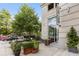 Outdoor seating area of a restaurant, landscaped with plants and small trees at 1820 Peachtree St # 1607, Atlanta, GA 30309