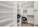 Well-organized walk-in closet with built-in shelving, hanging racks, and plenty of storage space at 1820 Peachtree St # 1607, Atlanta, GA 30309