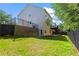 Spacious fenced backyard featuring lush lawn, multilevel deck and patio, and mature trees at 2517 Hampton Park Ct, Marietta, GA 30062