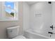 Clean bathroom featuring white tile tub surround and matte black shower hardware at 2517 Hampton Park Ct, Marietta, GA 30062