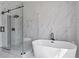 A luxurious primary bathroom with a soaking tub, and a walk-in shower with glass doors at 2517 Hampton Park Ct, Marietta, GA 30062