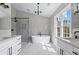 A luxurious primary bathroom with a soaking tub, a walk-in shower, and and vanities at 2517 Hampton Park Ct, Marietta, GA 30062