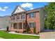 Classic two-story brick home with a charming front porch, manicured lawn, and attached garage at 2517 Hampton Park Ct, Marietta, GA 30062